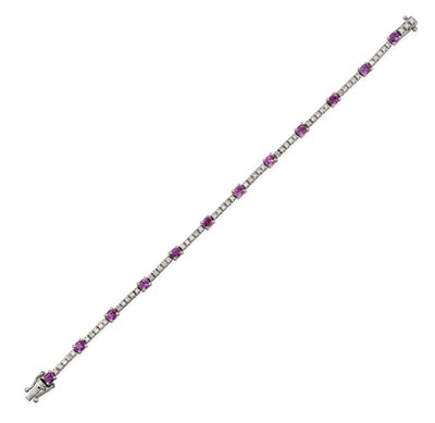 Lot 2098 - An 18 Carat White Gold Pink Sapphire and Diamond Bracelet, twelve oval pink sapphires alternate...