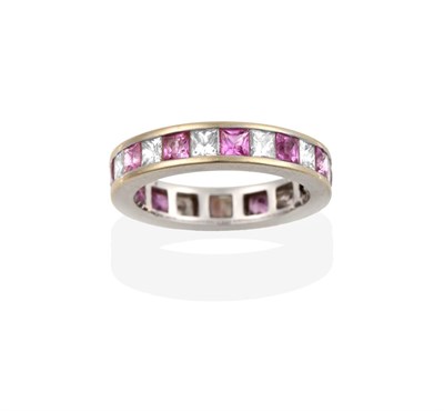Lot 2102 - An 18 Carat White Gold Pink Sapphire and Diamond Eternity Ring, princess cut diamonds alternate...
