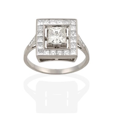 Lot 2105 - A Diamond Cluster Ring, the central princess cut diamond, in white claw settings, within a...