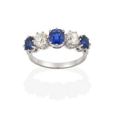 Lot 2106 - A Sapphire and Diamond Five Stone Ring, three oval cut sapphires alternate with two old cut...