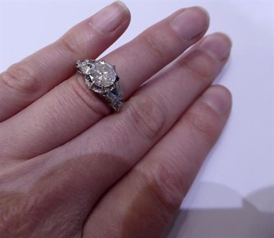 Lot 2109 - A Diamond Solitaire Ring, the round brilliant cut diamond in a white claw setting, to fancy...