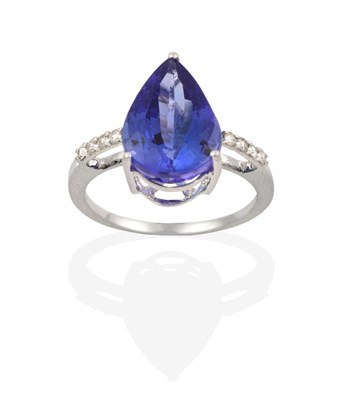 Lot 2110 - An 18 Carat White Gold Tanzanite and Diamond Ring, the pear shaped tanzanite in a claw setting,...