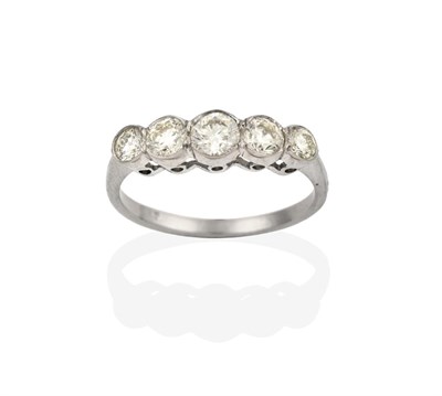 Lot 2112 - A Diamond Five Stone Ring, the graduated round brilliant cut diamonds in white rubbed over...