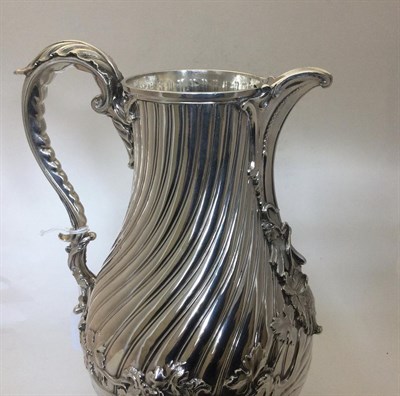 Lot 2202 - A George III Silver Wine-Jug, by Thomas Heming, London, 1765, pear-shaped and on spiral-fluted...