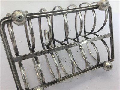 Lot 2231 - A Victorian Silver Toast-Rack, Probably by William Elliott, London, 1837, oblong and on four...