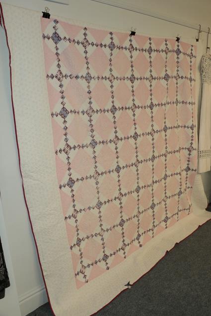 Lot 1040 - Large white cotton quilt appliqued with  pink diamond shaped patchworks and interspersed with...