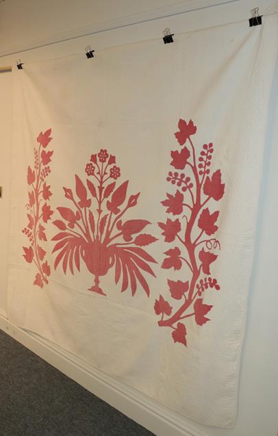 Lot 1041 - 19th century white quilt with large red cotton appliquéd image of a central pedestal vase of...