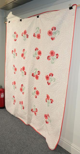 Lot 1042 - 20th century decorative American bed cover, worked in red threads, with applique flowers, with...