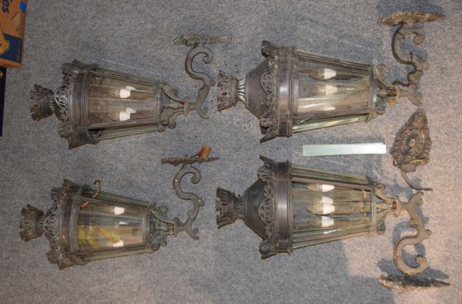Lot 1225 - A set of four Italian patinated metal garden lanterns, 80cm with scroll cast wall mounts and...