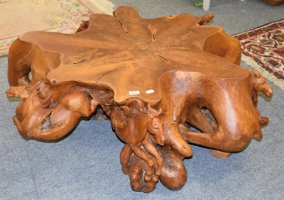 Lot 1237 - A burr yew wood coffee table, the base surmounted by six carved galloping horses, 120cm by 110cm by