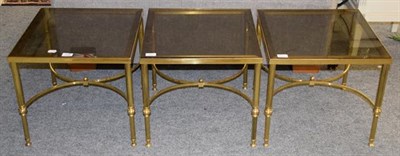 Lot 1238 - A set of three gilt brass and glass occasional tables, 45cm square by 42cm each