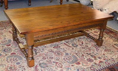 Lot 1241 - A Wood Brothers reproduction oak coffee table of rectangular form, raised on spindle turned...