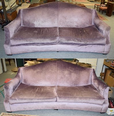 Lot 1245 - A pair of large curved purple upholstered four seater sofas, length 240cm
