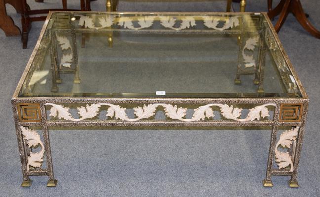 Lot 1246 - A modern patinated metal and glass coffee table with scrolling leaf and Greek key decoration...