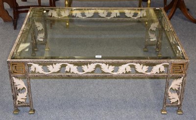Lot 1246 - A modern patinated metal and glass coffee table with scrolling leaf and Greek key decoration...