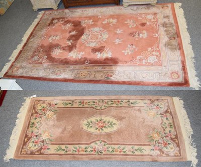 Lot 1253 - A Chinese carved carpet, the teracotta field with floral roundel enclosed by stylised vine...
