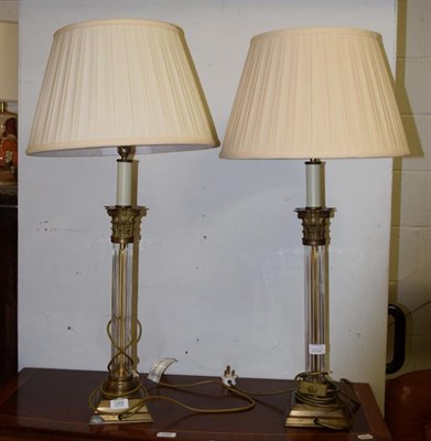 Lot 1266 - A pair of glass and gilt metal Corinthian columnar table lamps with silk shades, 62cm high