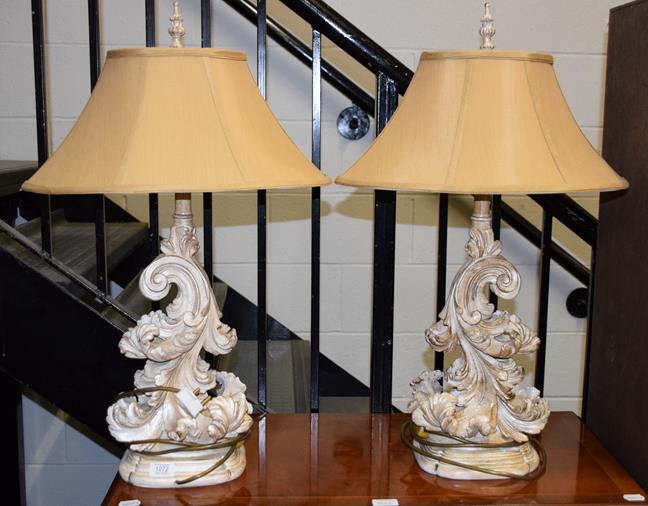 Lot 1272 - A pair of composition table lamps in the rococo taste modelled as scrolling acanthus leaves...