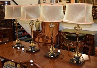 Lot 1275 - A set of four modern table lamps with silvered standards and gilt stylised petal decoration...