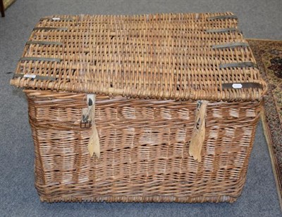 Lot 1277 - A large wicker hamper with carrying handles, 83cm by 65cm by 55cm
