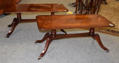 Lot 1279 - A pair of reproduction cross banded mahogany coffee tables, 99cm by 43cm by 43cm each