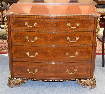 Lot 1290 - A reproduction cross banded and parcel gilt serpentine four-height chest of drawers, 108cm by...