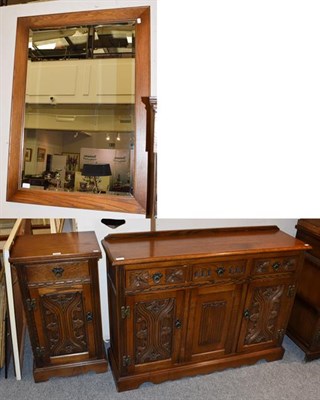 Lot 1297 - A Wood Brothers reproduction oak sideboard, the moulded top above three drawers with two carved...