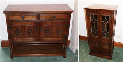 Lot 1298 - A Wood Brothers reproduction oak sideboard of two drawers above two lozenge carved cupboard...