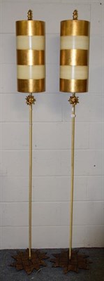 Lot 1304 - A pair of modernist standard lamps, the starbust bases issuing slender uprights with gilt...