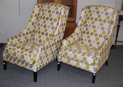 Lot 1306 - A pair of large modern green purple and cream printed wingback chairs, 115cm high