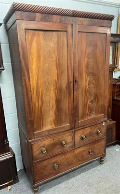 Lot 1313 - A Regency mahogany linen press with gadrooned cornice, brass handles and raised on turned feet,...