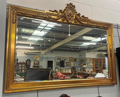 Lot 1315 - A reproduction gilt framed bevel glass over-mantel mirror, 145cm by 104cm