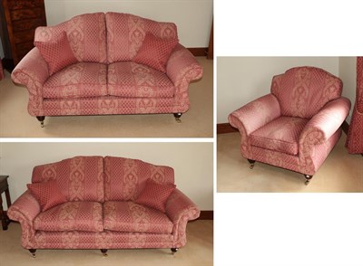 Lot 1320 - A three piece suite (modern) covered in pink floral fabric comprising a three seater sofa, 196cm by