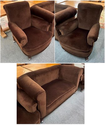 Lot 1327 - A 1920's three-piece suite comprising and sofa and two chair in brown upholstery