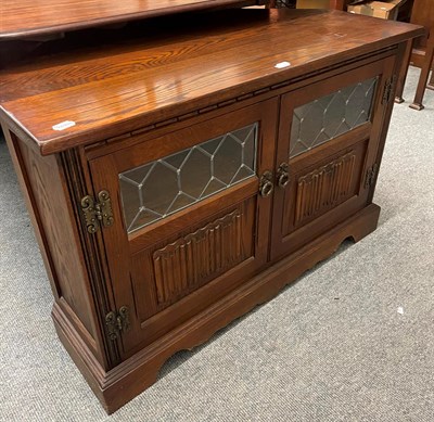 Lot 1344 - An old charm oak and lead glazed display cabinet, 134cm by 46cm by 189cm together with a...