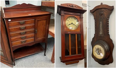 Lot 1345 - An early 20th century mahogany music cabinet with Art Nouveau copper handles, an oak barometer...
