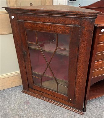 Lot 1346 - A George III oak hanging corner cupboard with glazed door and three internal shelves, 88cm by...