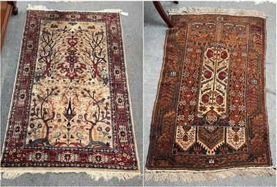 Lot 1347 - Baluch prayer rug, the camel field beneath triple Mihrabs enclosed by stylised vine borders,...