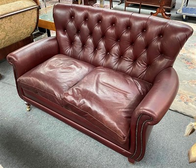 Lot 1386 - A modern buttoned-brown upholstered two-seater sofa, 140cm by 70cm by 86cm