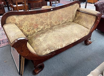 Lot 1387 - A Victorian mahogany framed scroll arm sofa carved with dolphins and raised of dolphin feet,...