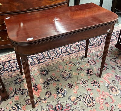 Lot 1391 - A Regency mahogany fold-over tea table on reeded legs, 90cm by 45cm by 75cm