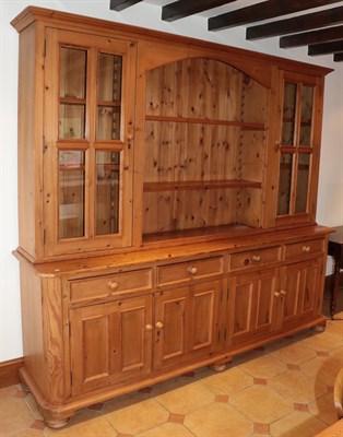 Lot 1406 - A reclaimed pine kitchen dresser, the upper section with glazed doors and the central section...