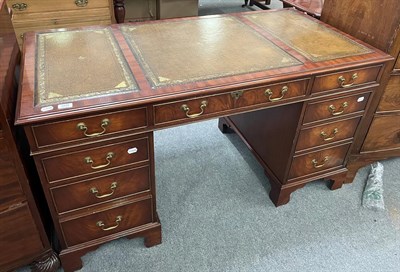 Lot 1409 - A 20th century mahogany veneered twin-pedestal writing desk, 138cm by 69cm by 75.5cm high