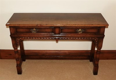 Lot 1421 - A Titchmarsh & Goodwin style reproduction oak two drawer table, with moulded drawers above an...