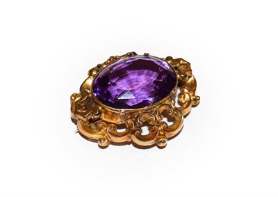 Lot 148 - A Victorian amethyst brooch, the oval cut amethyst in a yellow claw and rubbed over setting, in...