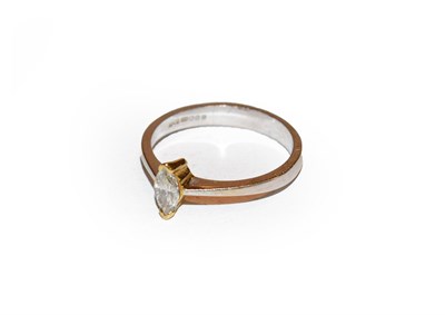 Lot 155 - An 18 carat gold diamond solitaire ring, the marquise cut diamond in a yellow claw, to a white...