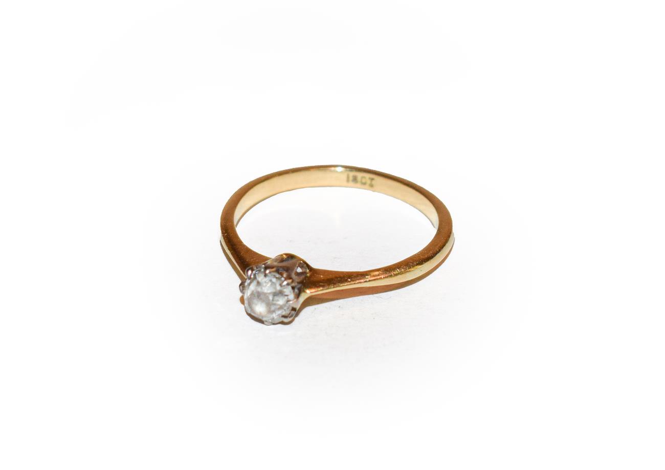 Lot 164 - A diamond solitaire ring, the old cut diamond in a white claw setting, to a yellow tapered shoulder