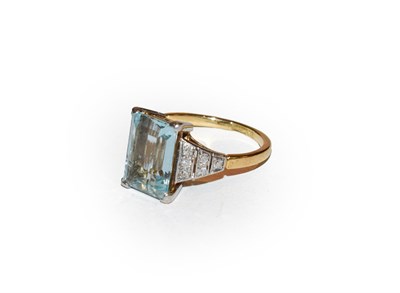 Lot 190 - An aquamarine and diamond ring, the step cut aquamarine in a white four claw setting, to an...