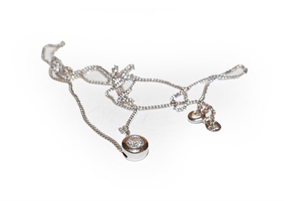 Lot 200 - An 18 carat white gold diamond solitaire pendant on chain, the round brilliant cut diamond in a...