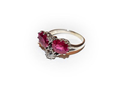 Lot 206 - A synthetic ruby and diamond ring, realistically modelled as a wishbone, formed of two oval cut...